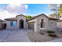 Charming single-story home featuring a tile roof, desert landscaping and neutral-toned stucco facade at 21050 E Tierra Grande --, Queen Creek, AZ 85142