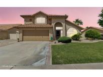 Charming two-story home featuring a well-maintained lawn and a two car attached garage at 2340 W Myrtle Dr, Chandler, AZ 85248