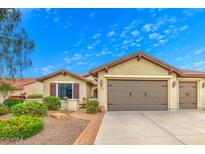 Charming single-story home with desert landscaping, two-car garage, and a welcoming front porch at 27158 W Potter Dr, Buckeye, AZ 85396