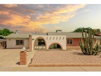 Charming single-story home featuring unique architectural details and desert landscaping with a decorative brick pillar mailbox at 3248 E Windrose Dr, Phoenix, AZ 85032
