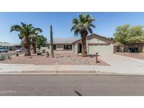 Charming single-story home with desert landscaping and palm trees in the front yard at 3300 N Coronado St, Chandler, AZ 85224