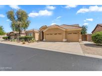 Charming single-story home featuring a three-car garage, desert landscaping, and a tile roof at 4809 E Red Range Way, Cave Creek, AZ 85331