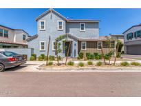 Charming two-story home featuring a combination of gray and brown siding with manicured landscaping at 4833 S Ferric --, Mesa, AZ 85212