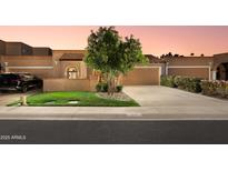 Charming single-story home with a well-manicured lawn and a two-car garage at 7710 N Via De Fonda St, Scottsdale, AZ 85258