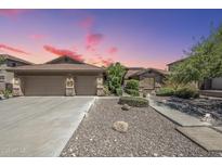 Beautiful single-Gathering home with a large garage, desert landscaping, and a long driveway at 9576 W Blue Sky Dr, Peoria, AZ 85383