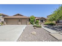 Charming single-story home featuring a three-car garage and well-manicured desert landscaping at 9576 W Blue Sky Dr, Peoria, AZ 85383