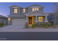 Charming two-story home featuring manicured landscaping and an attached two-car garage at 9856 E Palladium Dr, Mesa, AZ 85212