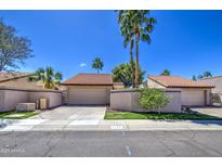 Charming single-story home featuring a well-maintained yard, attached garage, and classic southwestern architecture at 11144 N 109Th Way, Scottsdale, AZ 85259