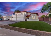Stunning two-story home with a manicured lawn, red tile roof, and a three-car garage at 1349 N Lakeshore Dr, Chandler, AZ 85226
