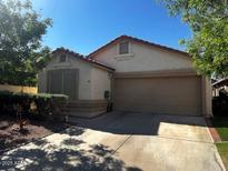 Inviting single-story home featuring a neutral color palette, a two-car garage and a well-maintained front yard at 1836 N Stapley Dr # 88, Mesa, AZ 85203