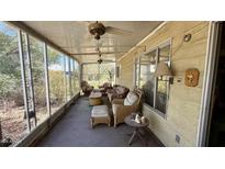 Relaxing enclosed patio with comfortable wicker furniture and ceiling fans for outdoor enjoyment at 201 S Greenfield Rd # 23, Mesa, AZ 85206