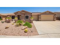 Charming single-story home with desert landscaping and a three car garage at 20427 N 88Th Dr, Peoria, AZ 85382
