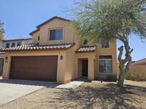 Charming two-story home with a two car garage, desert landscaping, and a tile roof at 20941 N Leona Blvd, Maricopa, AZ 85138