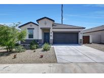 Charming single-story home featuring a well-manicured yard and a two-car garage at 23937 W Hopi St, Buckeye, AZ 85326