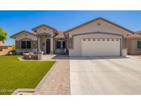 Charming single-story home with a well-manicured lawn and a spacious two-car garage at 2839 S Copperwood --, Mesa, AZ 85212