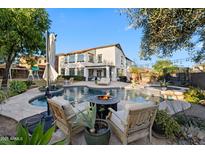 Inviting backyard pool area with in-pool seating and a cozy fire pit for outdoor entertaining at 28408 N 52Nd Way, Cave Creek, AZ 85331