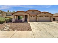 Charming single-story home with a well-maintained lawn and a spacious three car driveway at 4723 W Samantha Way, Laveen, AZ 85339