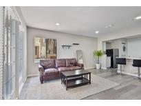 Cozy living room featuring a comfortable leather sofa, stylish coffee table, and a light-filled window at 4901 S Calle Los Cerros Dr # 119, Tempe, AZ 85282