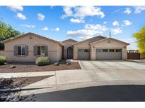 Charming single-story home with a three-car garage and well-maintained landscaping at 5543 W Kowalsky Ln, Laveen, AZ 85339