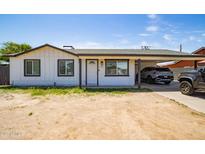 Charming single-story home with a carport, featuring a clean white facade and freshly painted trim at 6501 W Columbus Ave, Phoenix, AZ 85033
