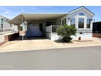 Charming mobile home showcasing ample covered parking and a well-maintained front yard at 7750 E Broadway Rd # 774, Mesa, AZ 85208
