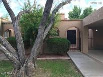 Charming home exterior featuring a covered driveway, desert landscaping, and an arched entryway at 913 E Beryl Ave, Phoenix, AZ 85020