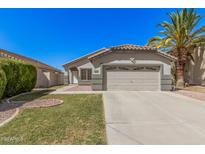 Charming single-story home features a two-car garage, well-manicured lawn, and lush landscaping at 924 E Baylor Ln, Gilbert, AZ 85296