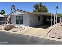 Charming single-story home features a carport and low-maintenance desert landscaping at 9302 E Broadway Rd # 49, Mesa, AZ 85208