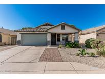 Charming single-story home features a desert landscaped front yard and a two-car garage at 9438 E Plana Ave, Mesa, AZ 85212