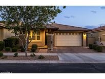 Charming single-story home featuring a two-car garage, brick driveway, and well-manicured landscaping at 10539 E Corbin Ave, Mesa, AZ 85212