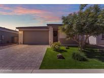 Charming single-story home featuring a low maintenance yard with a well-manicured tree and a paver driveway at 11357 E Unger Ave, Mesa, AZ 85212