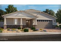 Charming single-story home with brick accents, a two-car garage, and desert landscaping at 17677 W Odeum Ln, Goodyear, AZ 85338