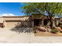 Tan single story home featuring desert landscaping and a three car garage at 25845 N 44Th Ave, Phoenix, AZ 85083