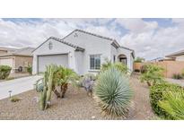 Charming single-story home featuring desert landscaping, a two-car garage, and a neutral-toned exterior at 25946 W Cat Balue Dr, Buckeye, AZ 85396