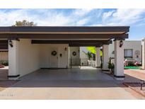 Attached covered carport with direct access to the front door and private outdoor space at 2938 S Country Club Way, Tempe, AZ 85282