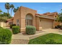 Inviting home with stucco exterior, tile roof, manicured landscaping, and attached two-car garage at 3234 E Briarwood Ter, Phoenix, AZ 85048