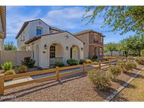 Beautiful two-story home featuring a light-colored stucco exterior with a charming arched entryway at 3828 S Verbena Ave, Gilbert, AZ 85297