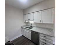 Modern kitchen with stainless steel appliances, granite countertops, and white cabinetry at 555 N May -- # 29, Mesa, AZ 85201