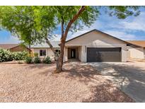 Charming single-story home featuring a well-maintained yard and a two car garage at 7232 W Sunnyside Dr, Peoria, AZ 85345
