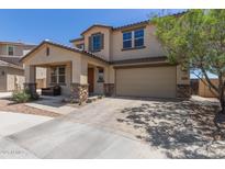 Charming two-story home with a well-manicured front yard, a paved driveway, and a large garage at 8737 E Nichols Ave, Mesa, AZ 85209