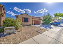 Charming single-Gathering home featuring a two-car garage, desert landscaping, and a welcoming facade at 9413 W Williams St, Tolleson, AZ 85353
