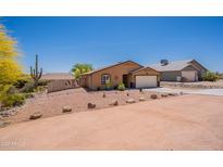 Charming single-story home featuring desert landscaping, a two-car garage, and a well-maintained yard at 10177 E La Palma Ave, Gold Canyon, AZ 85118