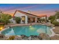 Enjoy this stunning backyard with pool, beautiful landscaping, and covered patio at 10907 E Bella Vista Dr, Scottsdale, AZ 85259