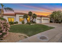 Charming single-story home boasting a well-manicured lawn, a three-car garage, and a tile roof at 10907 E Bella Vista Dr, Scottsdale, AZ 85259