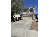 Charming two-story home featuring a two-car garage and well-maintained front yard landscaping at 11460 W Eden Mckenzie Dr, Surprise, AZ 85378