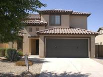 Charming two-story home with a two-car garage, tile roof, and low maintenance desert landscaping at 14200 W Larkspur Dr, Surprise, AZ 85379