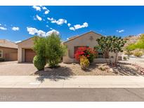 Charming single-story home with desert landscaping and a brick-paved driveway at 14552 S 182Nd Dr, Goodyear, AZ 85338