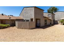 Two-story townhome featuring a private gravel front yard and neutral stucco facade at 15407 N 2Nd St, Phoenix, AZ 85022