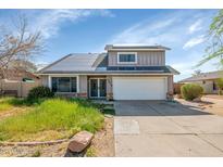 Charming two-story home featuring a two-car garage, solar panels, and front yard at 17819 N 46Th Dr, Glendale, AZ 85308