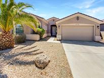 Charming home featuring a two-car garage, well-manicured desert landscaping, and beautiful curb appeal at 18207 W Marshall Ln, Surprise, AZ 85388